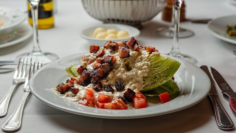 Iceberg wedge salad topped with bacon and blue cheese