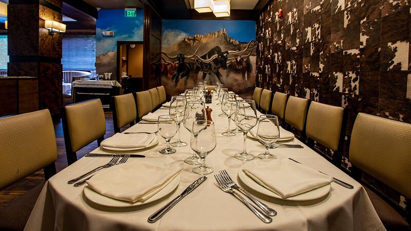 Private dining room with painting of bulls of the wall